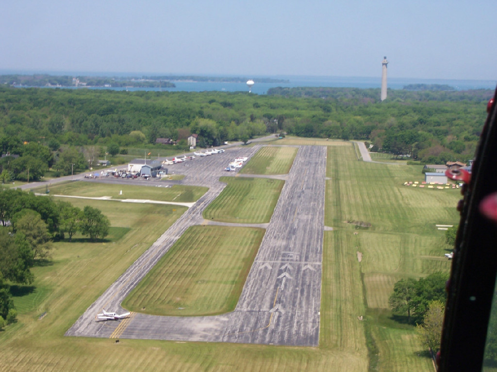 An aerial view of a runway and trees.