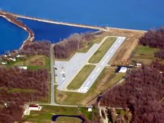 An aerial view of a runway and the water.