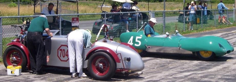 A group of people riding on the back of cars.